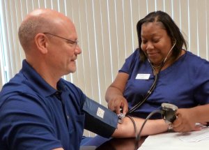 Mike Reader having his blood pressure taken by a Healics, Inc., nurse during our annual onsite biometric testing.