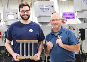 August Pillar Among Peers Recipient, Tyler M., pictured with COO Dave Strand